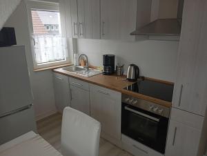 a kitchen with a sink and a stove top oven at Ferienwohnung Greinert in Bad Pyrmont