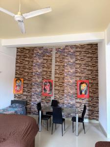 a room with a brick wall with a table and chairs at Samira House in Mombasa