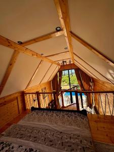 a large room with a bed in the attic at Onyx Vikendica 1 