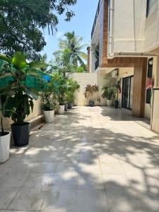 a sidewalk with potted plants and a building at The Soul Stones Villas in Vagator