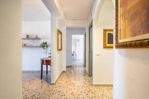 a hallway with a table in a room with white walls at Centoquaranta Apartment in Terrasini