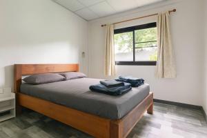 a bedroom with a bed with two towels on it at PaiPaiHostel in Pai