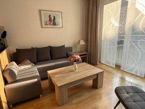 a living room with a couch and a coffee table at Seebrise Saarow in Bad Saarow