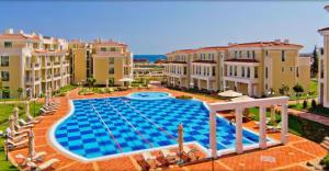 a large swimming pool in the middle of some buildings at Flores Gardan ART Studio in Chernomorets