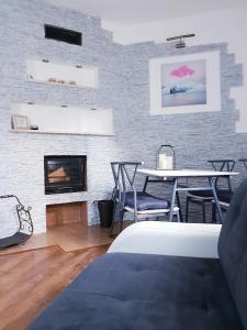 a living room with a fireplace and a table and chairs at Apartamenty Biały Kamień in Wałbrzych