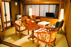 a living room with a table and chairs at 飛騨棲家 八幡宿 - Hida Sumika Hachimanyado in Takayama