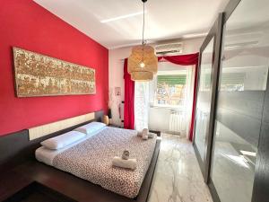 a bedroom with a red wall with a bed in it at PENTHOUSE LUXE - Rome in Rome