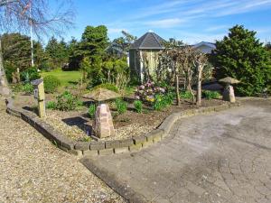 a garden with a stone walkway in front of a house at Luxury Retreat in Bork Havn - By Traum Ferienwohnungen in Hemmet