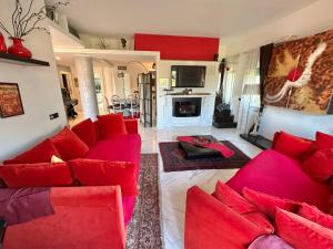 a living room with red couches and a fireplace at Penthouse Luxe - Rome in Rome