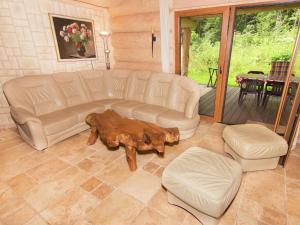 a living room with a couch and a coffee table at Family log cabin in the Alps in Ruhpolding