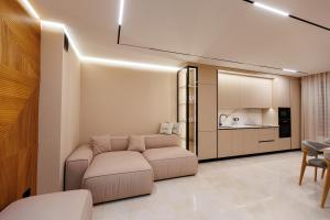 a living room with a couch and a kitchen at Modern luxury apartment 8 in Chişinău