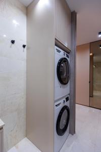 a laundry room with a washer and dryer at Modern luxury apartment 8 in Chişinău