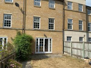 a brick building with a door and a fence at Woodstock in York