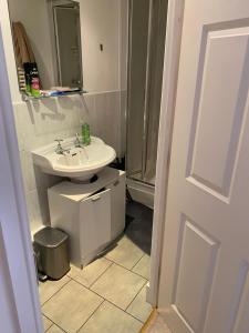 a white bathroom with a sink and a shower at Woodstock in York
