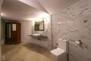 a bathroom with a toilet and a sink at Kutch Safari Resort in Kunria