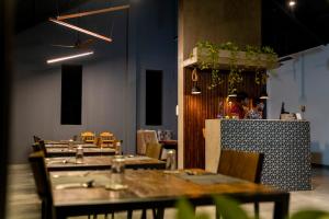 a restaurant with wooden tables and chairs and a counter at Area 4 eco cubes in Ella