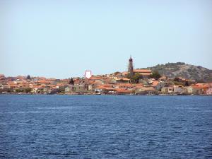 a large body of water with a town in the background at Voltera Apartments in Betina Old Town, with Parking Nearby in Betina