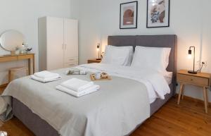 a bedroom with a bed with two towels on it at Central Thessaloniki Boutique in Thessaloniki