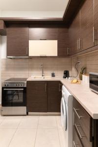 a kitchen with a sink and a stove at Central Thessaloniki Boutique in Thessaloniki