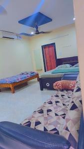 a room with three beds and a blue ceiling at Sunrise beach resort perupalem in Perupalem