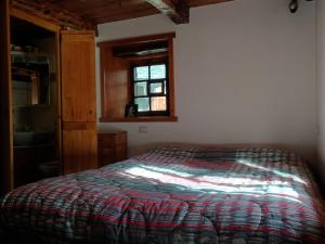 a bedroom with a bed and a window at VERO RUSTICO ALPiNO in Madesimo