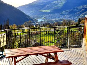 a wooden bench sitting on a balcony overlooking a valley at Location Paradiski San Bernardo in Séez