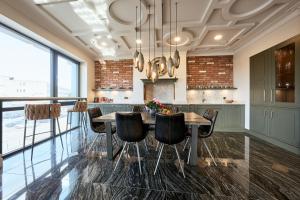 a kitchen with a wooden table and chairs at Old Town Pearl Suite in Kaunas