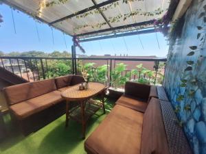 a living room with a couch and a table on a balcony at Lily Aparts in Varna City