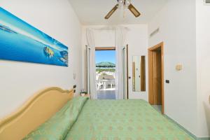 a bedroom with a bed and a view of the ocean at Hotel Villa Paradiso in Ischia Town +31 photos