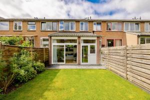 an exterior view of a house with a fence at Family home in Haarlem with garden, near beach & Amsterdam in Haarlem