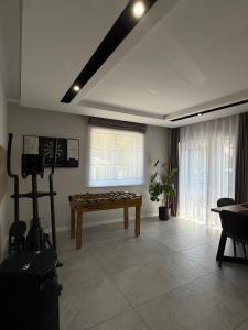 a living room with a game table in the corner at Pokoje Gościnne A i M Dendys in Korbielów