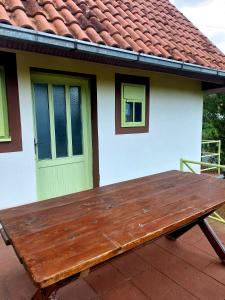 a wooden bench sitting in front of a house at Vikendica V&V in Jazak