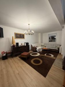 a large living room with a chandelier and a couch at Vuglovec House in Vuglovec