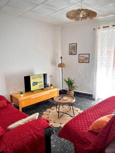 a living room with a couch and a table at Casa caloret 1r Pl 2 minutos de la playa y del centro in Vinaròs