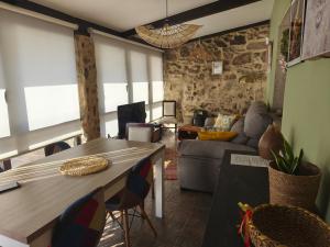 a living room with a table and a couch at O Remanso Devesa in Pontevedra