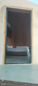 a window in a room with a bed in it at Shadow of Rum camp in Wadi Rum +15 photos