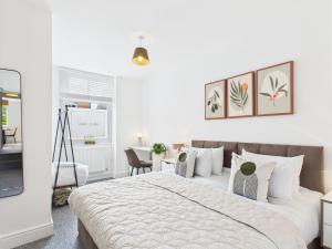 een slaapkamer met een groot bed en een bureau bij Spacious Apartment with Private Garden in Norwich