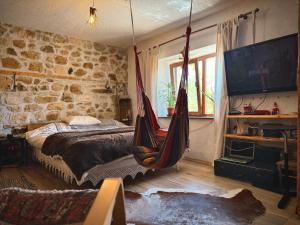 a bedroom with a bed and a hammock at Books Houses in Beden