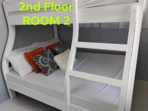 a white bunk bed with a ladder and floor room at Diocades Residence - Capitol Hills in Bacolod