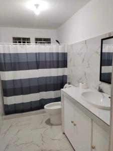 a bathroom with a sink and a toilet and a shower at Diocades Residence - Capitol Hills in Bacolod