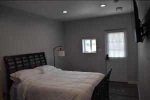 a bedroom with a bed and a window and a door at Tanersville Village Rooms on Saw Mill Creek in Tannersville