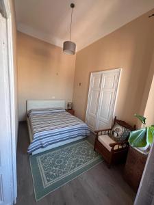 a bedroom with a bed and a door and a rug at Ausra in Olbia +8 photos