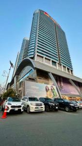 a large building with cars parked in front of it at Paramount Stay in Islamabad +5 photos