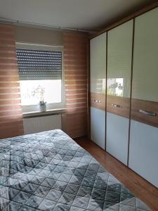 a bedroom with a bed and a window at Ferienwohnung Marita in Rietberg