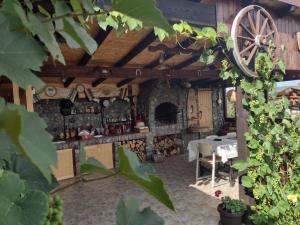 a room with a stone fireplace and a table and chairs at Moșia lu' Mișu in Ocna Sibiului