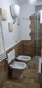a bathroom with two toilets and a shower at Casa vacanza luisa in Sezze