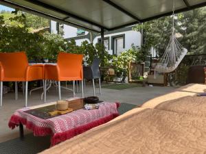 a bed and chairs and a table and a hammock at Private Room & Terrace in Skopje +8 photos