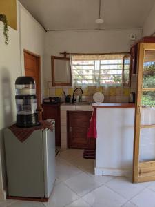 a kitchen with an old refrigerator and a counter at Charmante petite maison toute équipée in Talata-maty