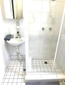 a bathroom with a shower and a sink at FlexiRoom on Abercrombie in Sydney