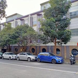 a group of cars parked in front of a building at FlexiRoom on Abercrombie in Sydney